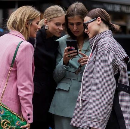 a group of women looking at their phones