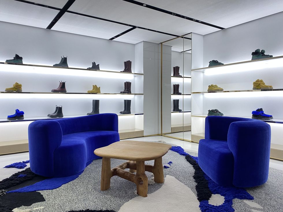 a room with blue couches and shelves