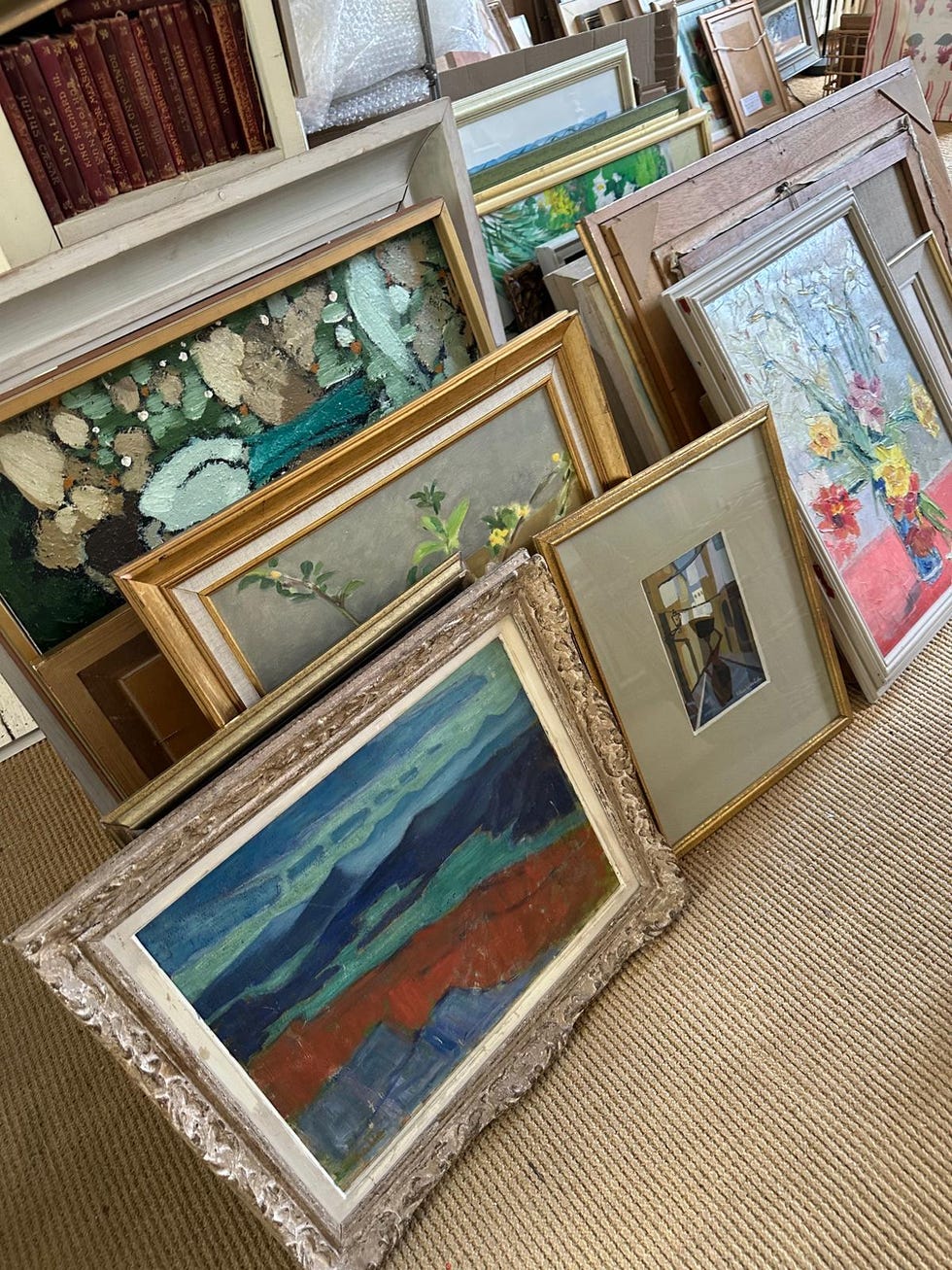 collection of framed paintings and artwork