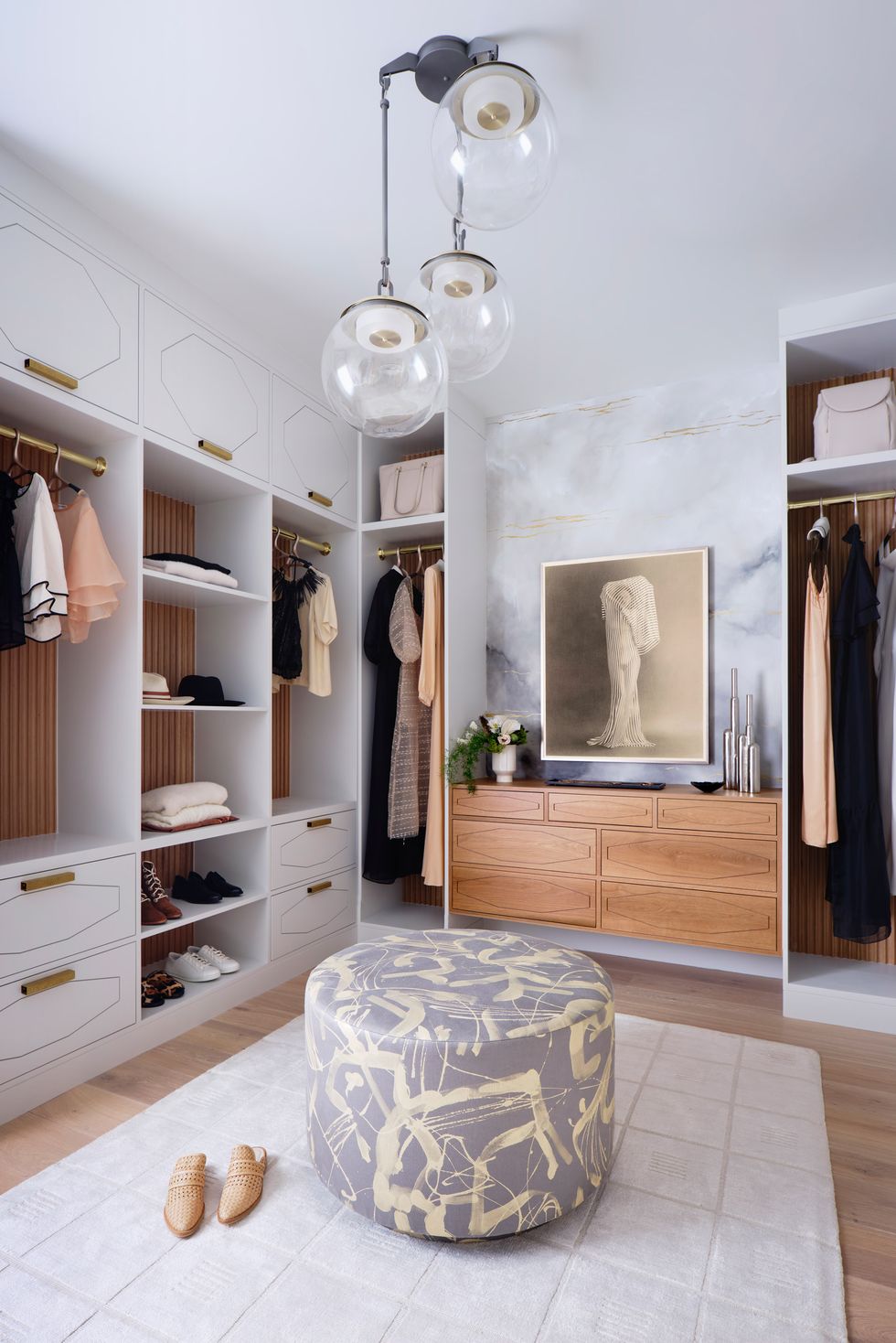 Walk-in closet with art and ottoman