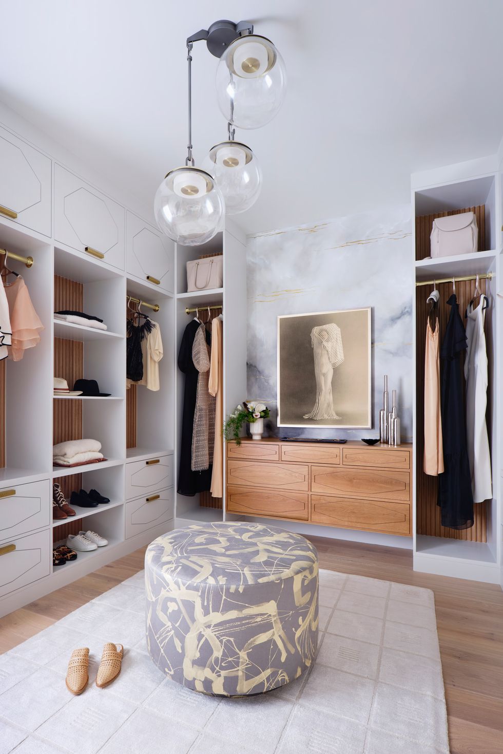 walk in closet with art and ottoman