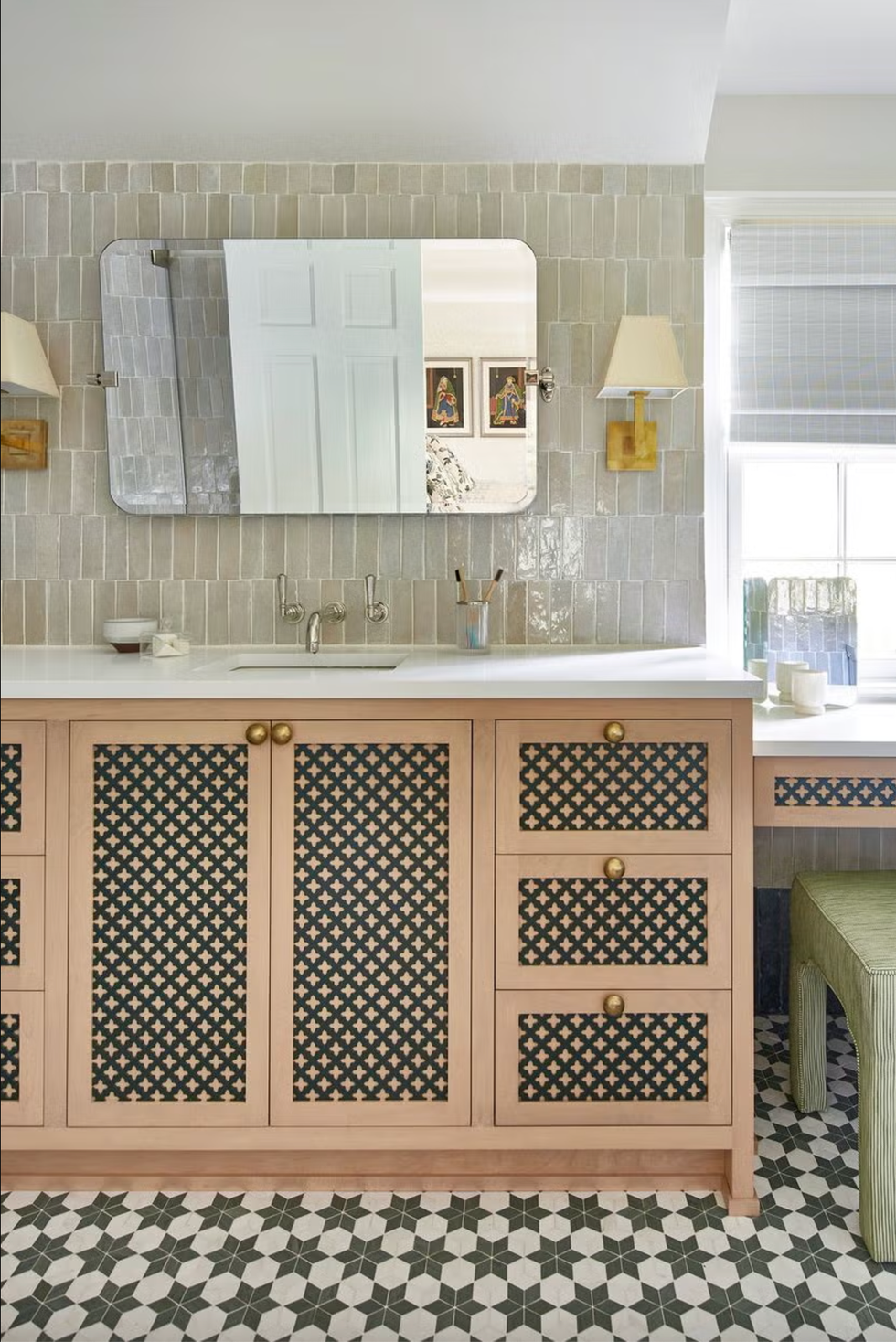 bathroom with patterned cabinetry and wallmounted mirror