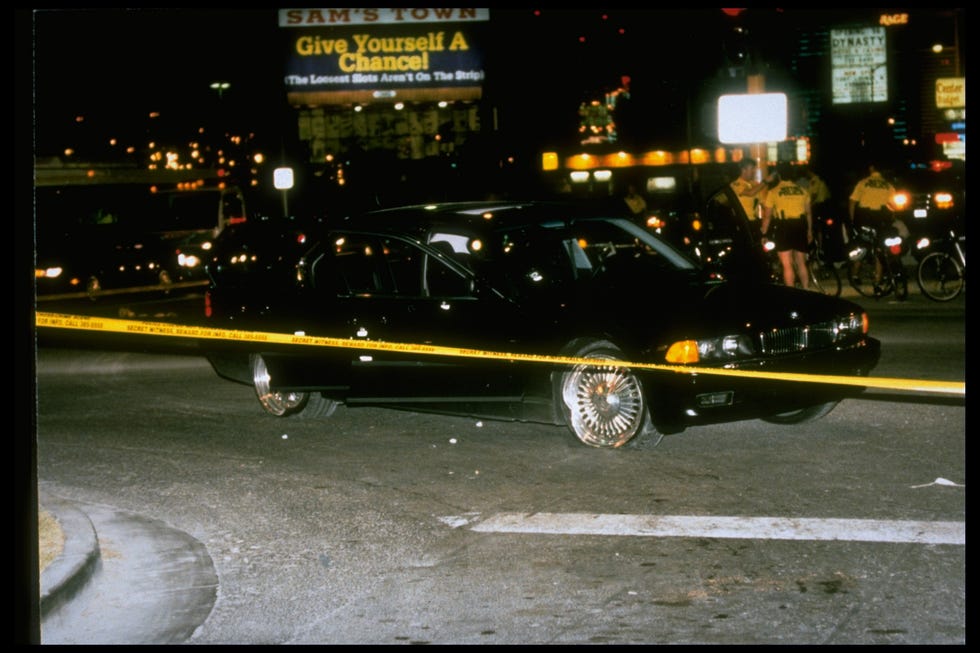 Black car in which rapper Tupac Shakur was fatally shot by unknown driveby assassins as he was riding w. friend Death Row records. pres. Marion Suge Knight, who survived shooting, behind police tape at crime scene