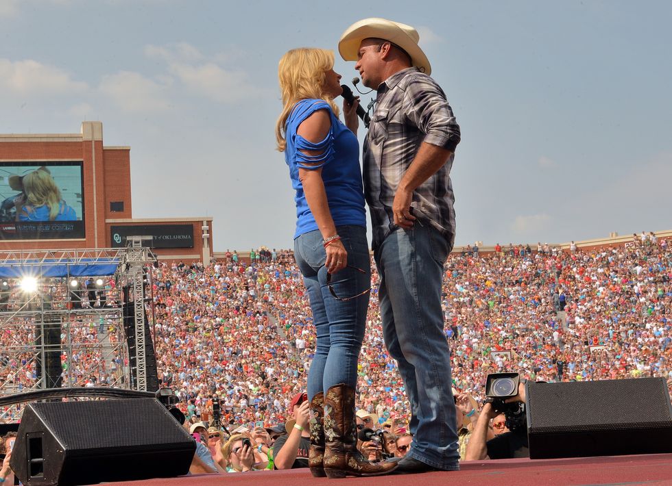 Trisha Yearwood and Garth Brooks perform during the Oklahoma Twister Relief Concert at Gaylord Family Oklahoma Memorial Stadium on July 6, 2013, in Norman, Oklahoma.