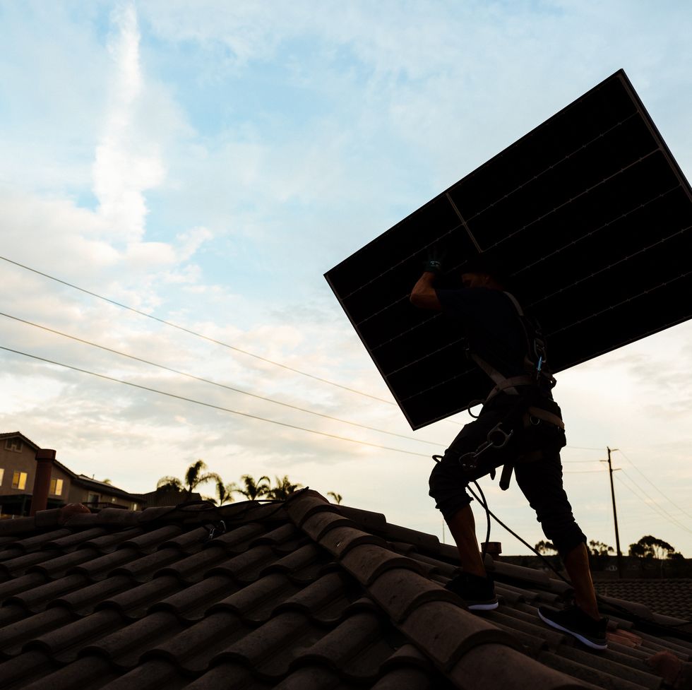 a person installing a solar panel