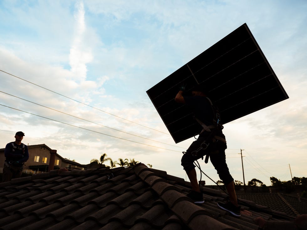 a person installing a solar panel