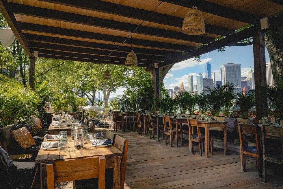a wooden deck with tables and chairs