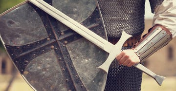 a photo of a knight in armor holding a sword and shield