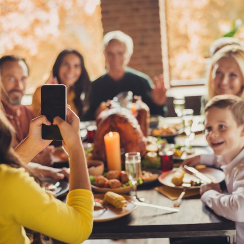 family meeting served table thanksgiving dinner little girl hold telephone