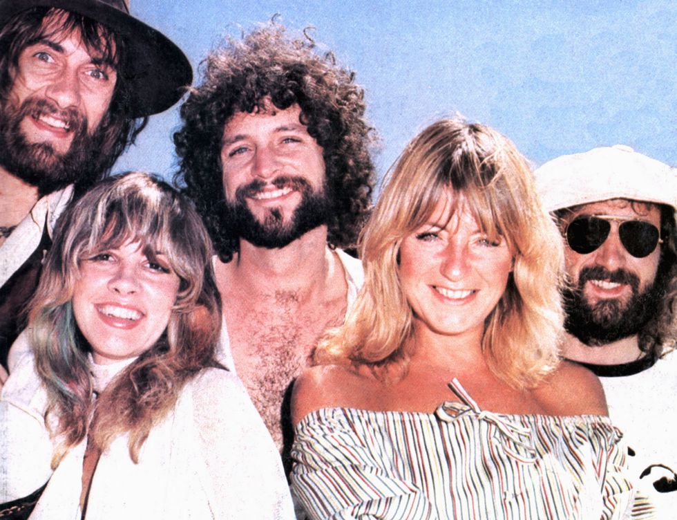 mick fleetwood, stevie nicks, lindsey buckingham, christine mcvie, and john mcvie smile and pose for a photo together