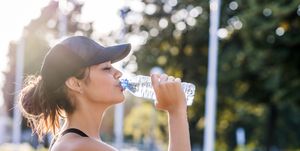 sporty young woman drinking water