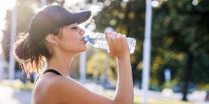 sporty young woman drinking water