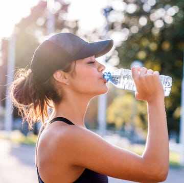 Photo of Sporty young woman drinking water drinking water