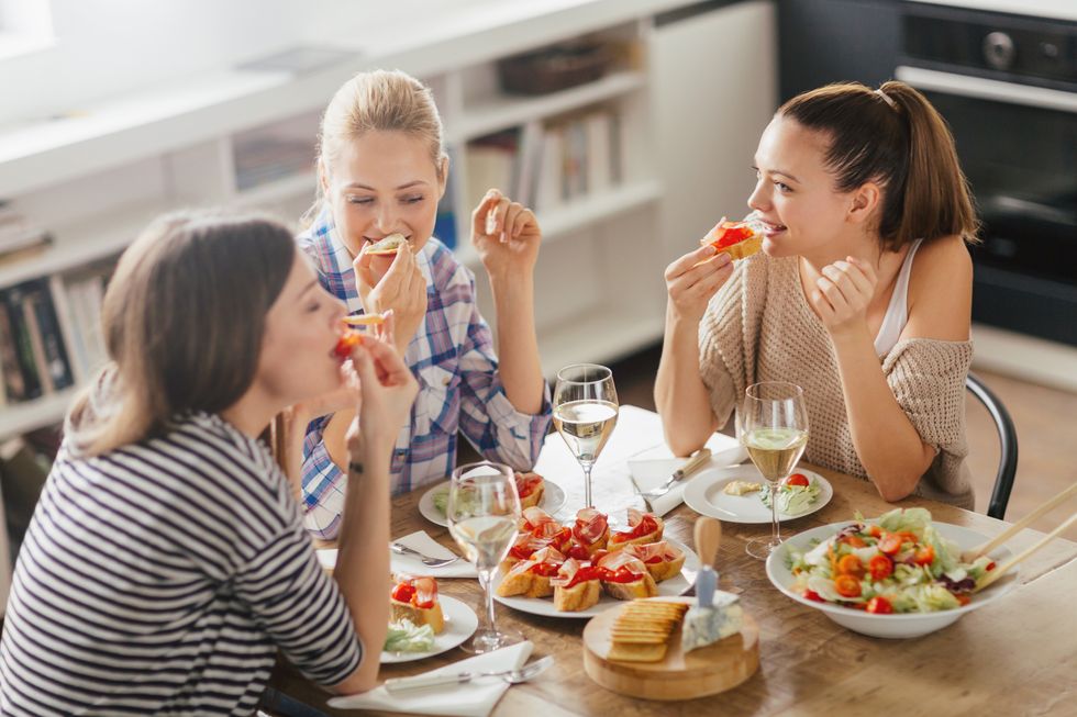 three women enjoying appetizers and wine