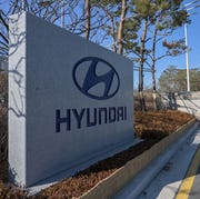 SKOREA-CHINA-HEALTH-VIRUS-ECONOMY-HYUNDAI a stone sign with hyundai written on it and the hyundai logo engraved