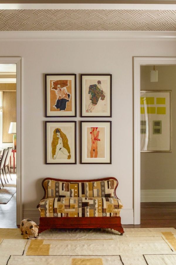 family photo wall ideas, four part photo wall in a room with with two entrances