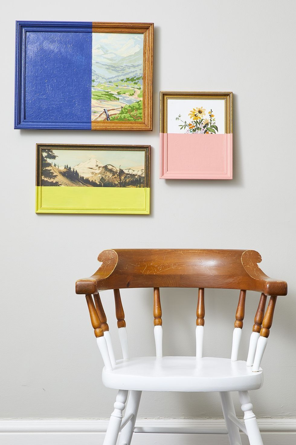 family photo wall ideas, a wall with half painted artworks and a chair painted in white at the bottom