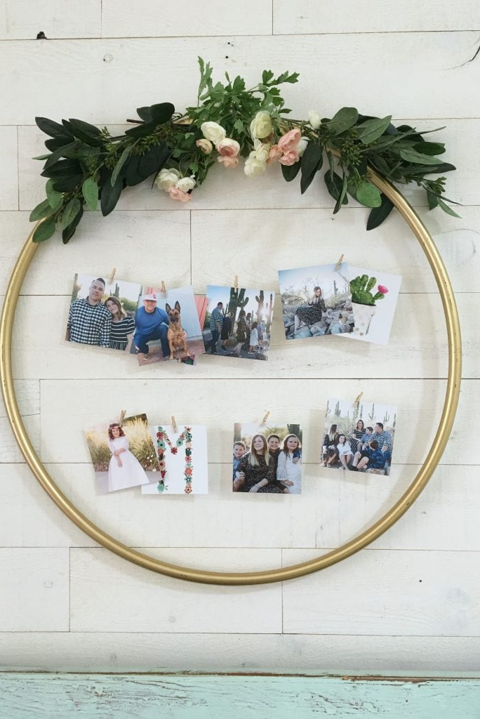 family photo wall ideas, gold hula hoop with faux flowers and photos clipped to the center