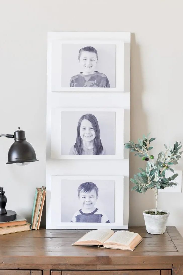 family photo wall ideas, white pocket organizer against the wall with child photos inside