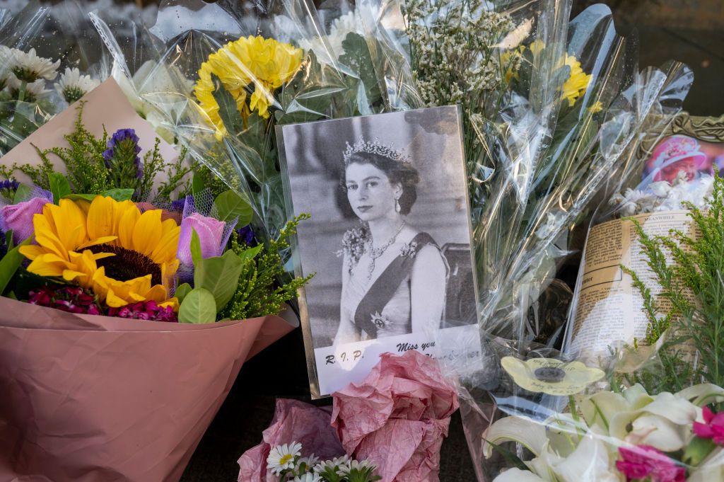 a photograph of queen elizabeth ii surrounded by flowers