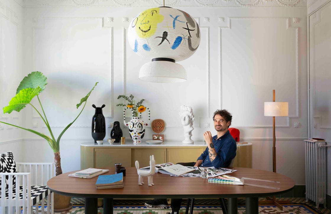 a person sitting at a desk with their feet up