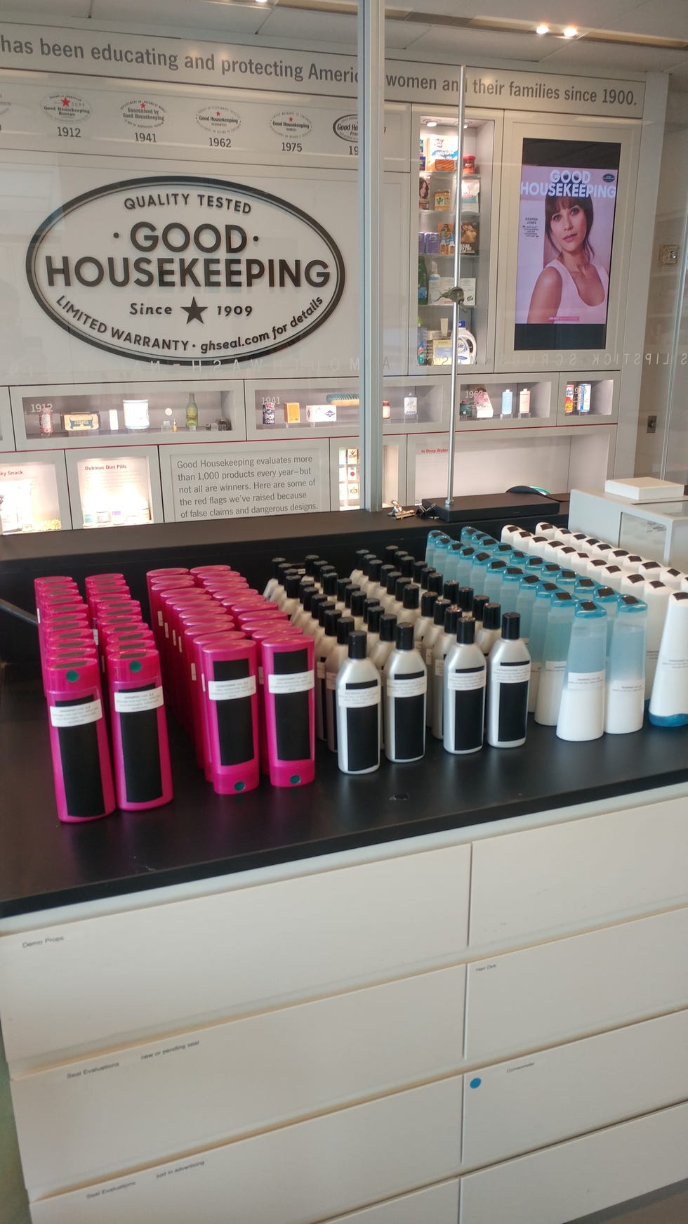display of various skincare or cosmetic products in distinct colors and containers