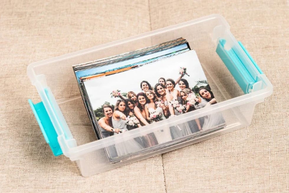 a plastic storage container filled with photographs