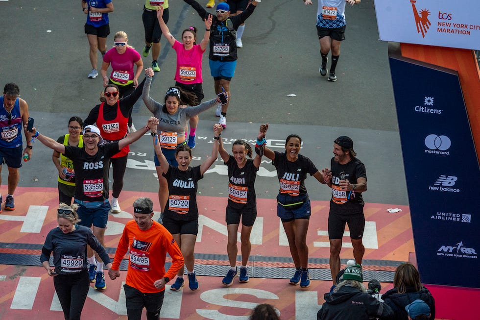 participants celebrating at the new york city marathon finish line