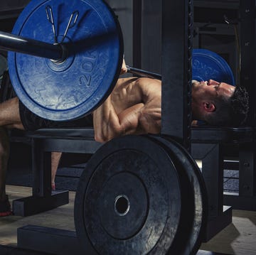 physical athlete doing barbell bench presses