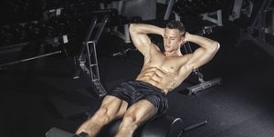 Athlete exercising his abs with glute ham developer