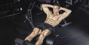 Athlete exercising his abs with glute ham developer