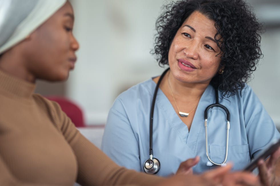 Physician consults female cancer patient