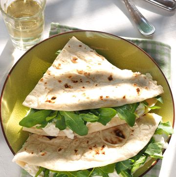 piadina with squacqurone cheese and rucola salad is a thin italian flatbread typically prepared in the romagna region emilia romagna italy europe