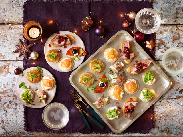 Christmas canapés with fairy lights, candles and decorations  