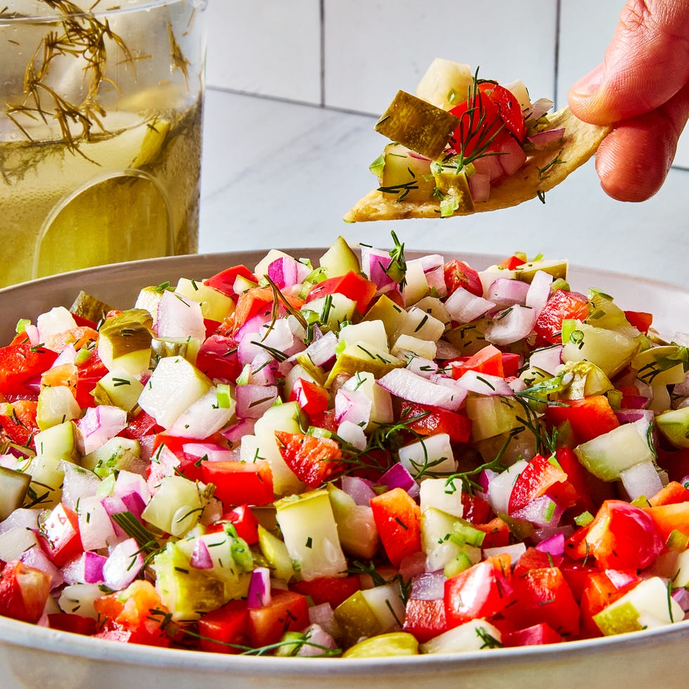 chopped pickles, tomatoes, and onions in a bowl with tortilla chips
