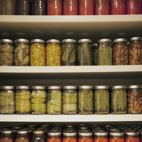 pickle jars arranged on shelves at market