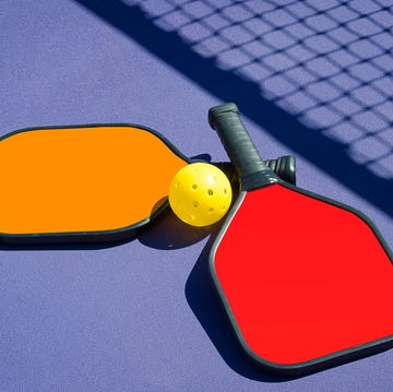 two paddles and a ball in net shadow