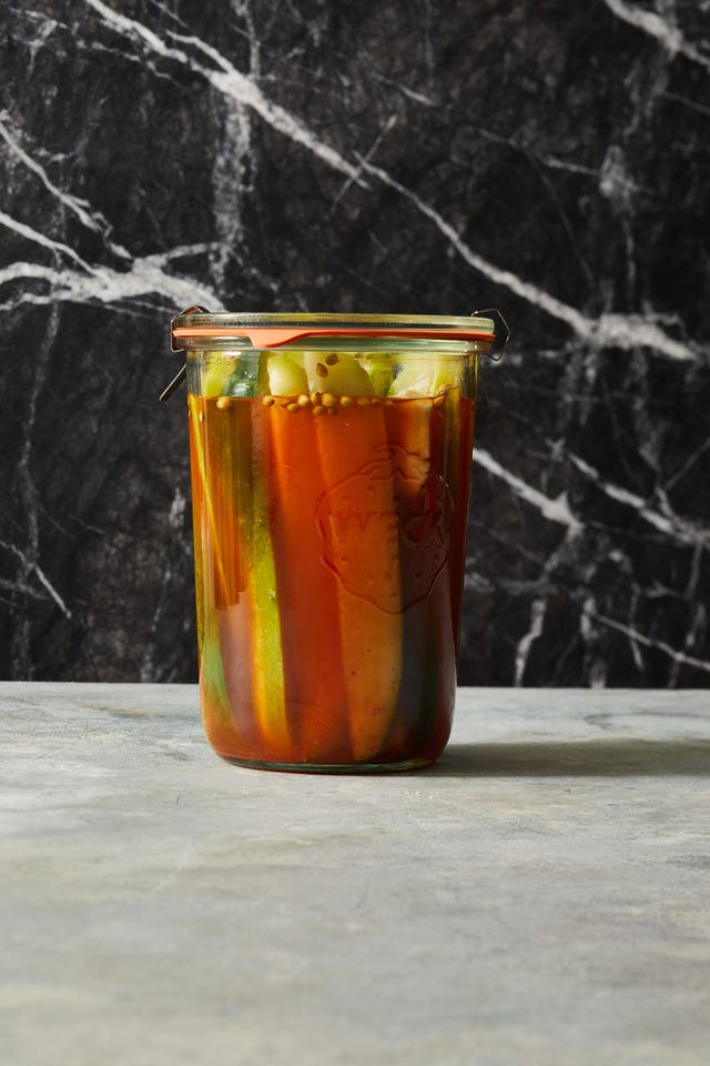 pickles with a kick in a jar on black marble background