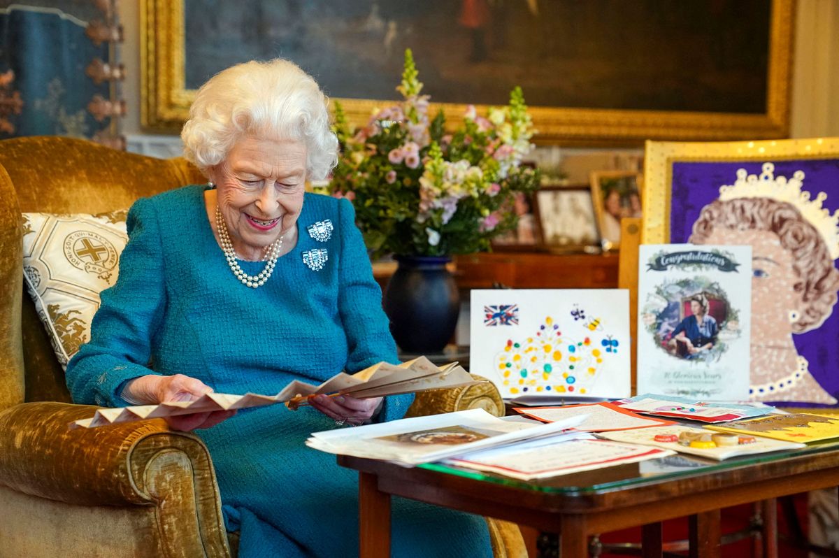 britain's queen elizabeth ii looking at queen victoria's autograph fan, alongside a display of memorabilia from her golden and platinum jubilees, in the oak room at windsor castle, west of london