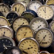 a collection of old car clocks and odometers