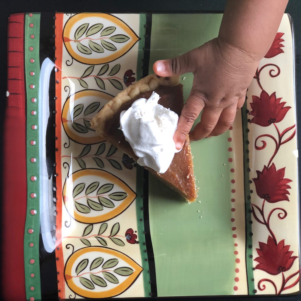 baby hand touching pie