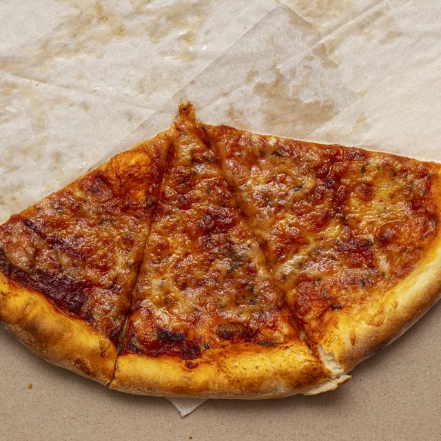 piece of pizza in cardboard pizza box pizza box with leftowers top view