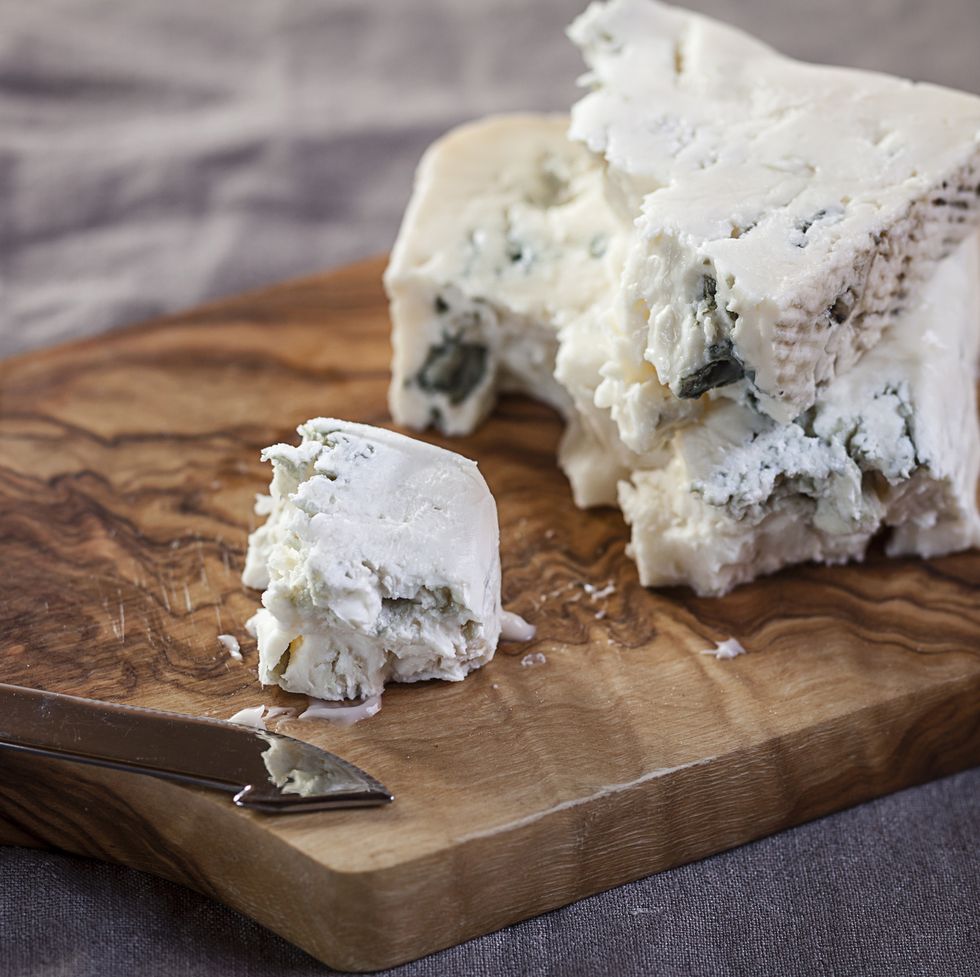 pieces of gorgonzola cheese on chopping board