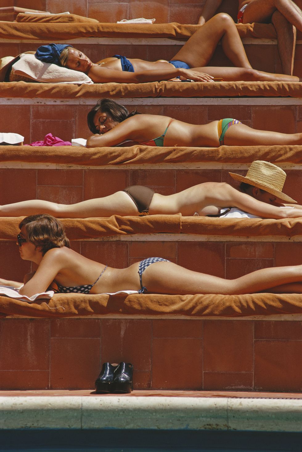 sunbathers by a swimming pool at the hotel punta tragara on the island of capri, italy, august 1974 photo by slim aaronsgetty images