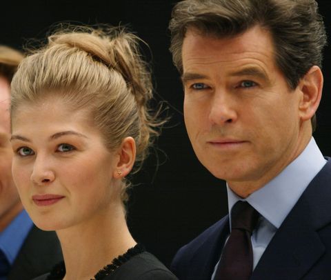 Pierce Brosnan (R) poses with Rosamund Pike (C) an