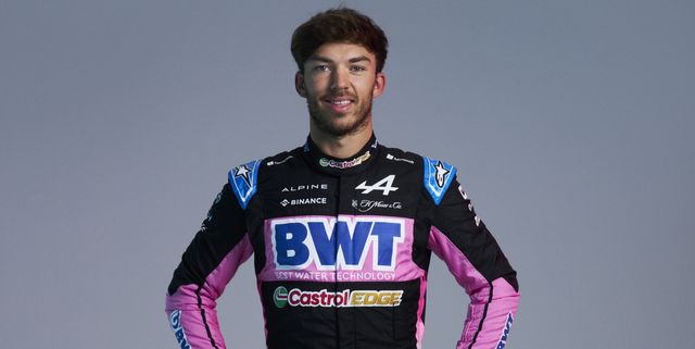 a man wearing a purple and black track suit