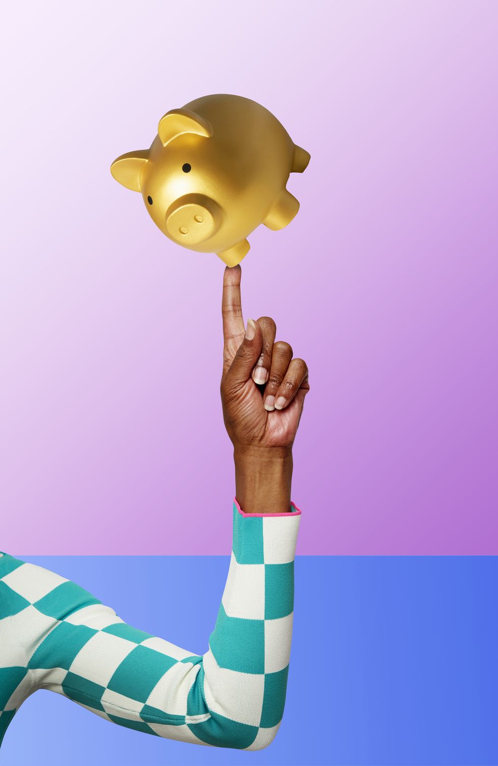 piggy bank balancing on finger