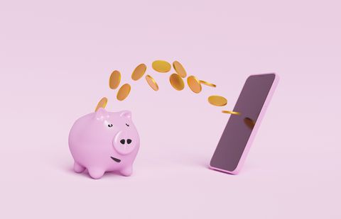 piggy bank with coins flying towards a mobile phone