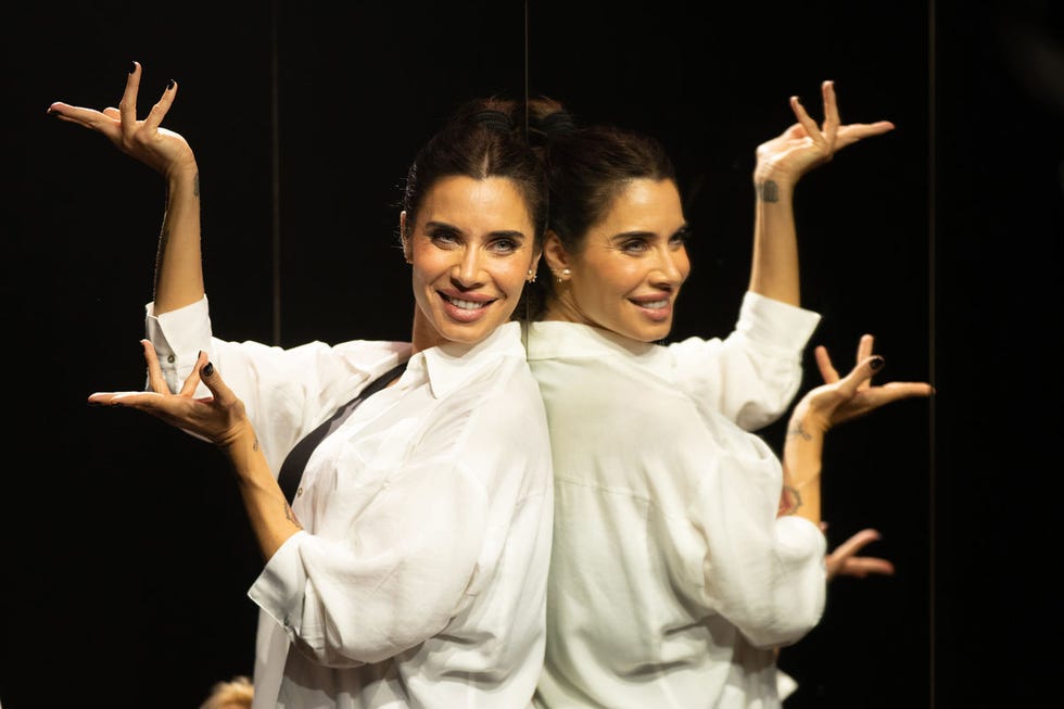 a couple of women in white karate uniforms with their hands up
