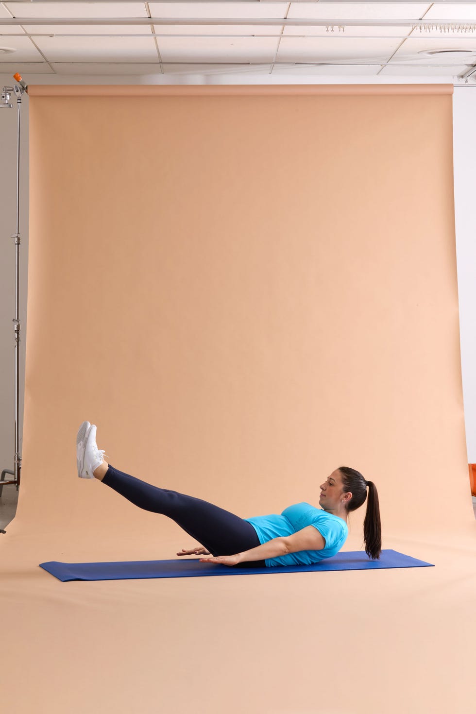 pilates 100 demonstration of a core workout exercise on a yoga mat